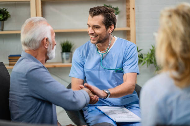 Healthcare professional shaking hands with a smiling senior patient to signify care and partnership